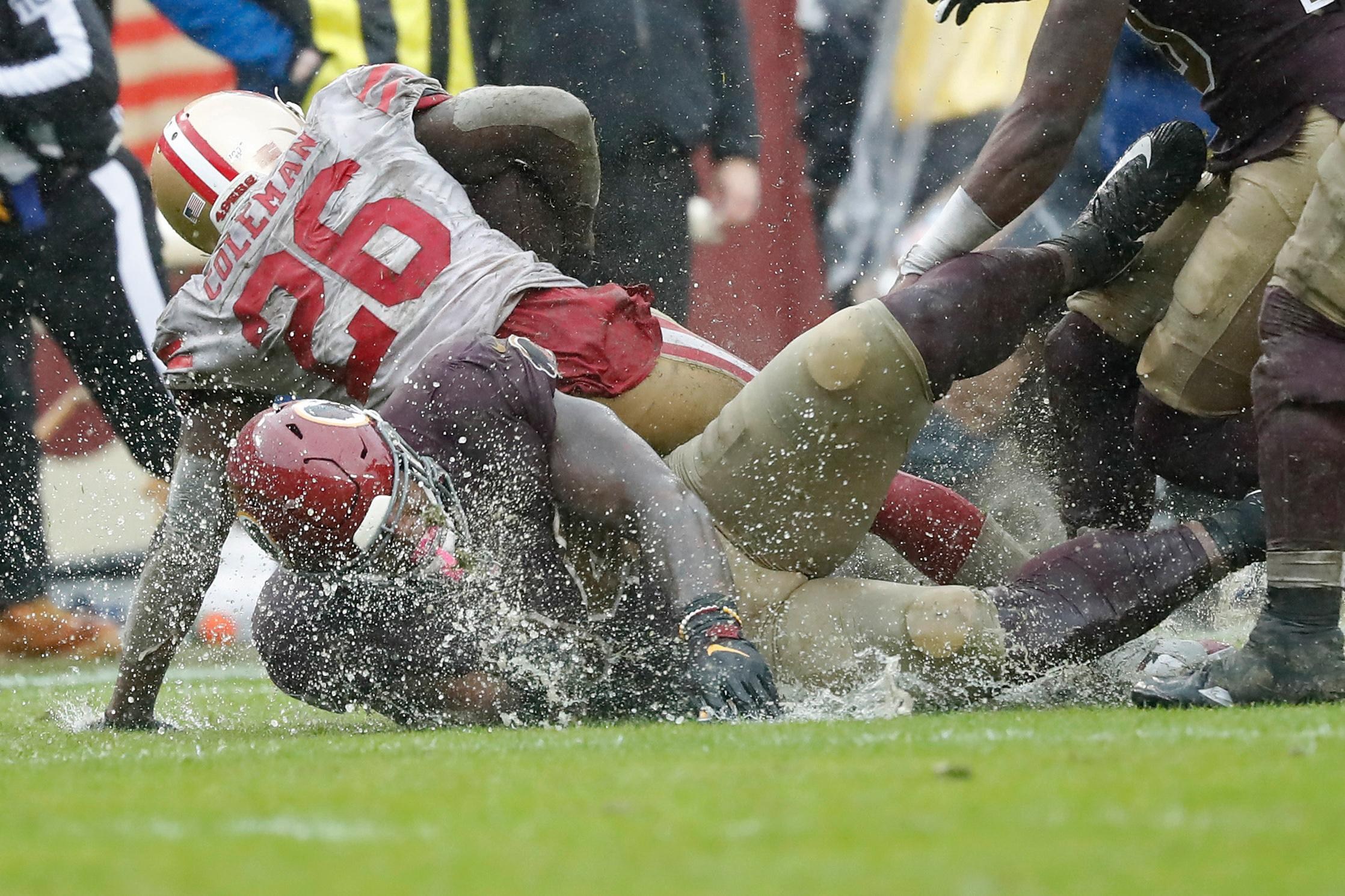 Oct 20, 2019; Landover, MD, USA; Washington Redskins nose tackle Daron Payne (94) tackles San Francisco 49ers running back Tevin Coleman (26) at FedExField. Mandatory Credit: Geoff Burke-Imagn Images