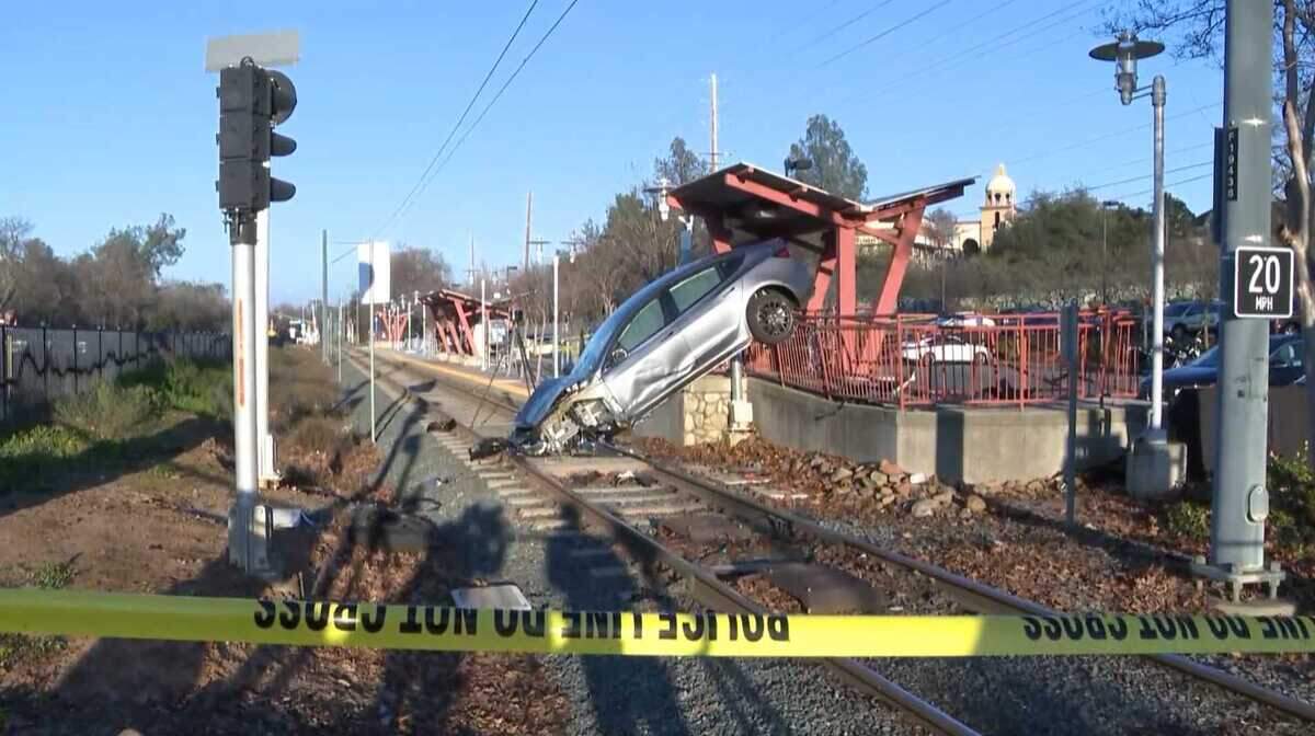 A Tesla Model 3 involved in the crash that killed 22-year-old dance instructor Elinor Steffy rests on the Iron Point Station platform and tracks in Folsom on Jan. 22. The Sacramento County District Attorney's Office declined to file criminal charges against the driver, citing insufficient evidence of criminal conduct and concluding the driver experienced a medical condition, while Steffy's family is pursuing a civil claim alleging inadequate pedestrian protections at the station.