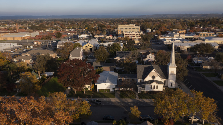 Steeple, buildings, and lush trees in downtown Lincoln, California
