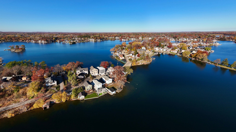 Portion of Lake Orion, Michigan, with houses on islands and autumn foliage