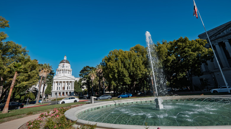 A fountain sprays water at Capitol Park, in front of the California State Capitol Building.