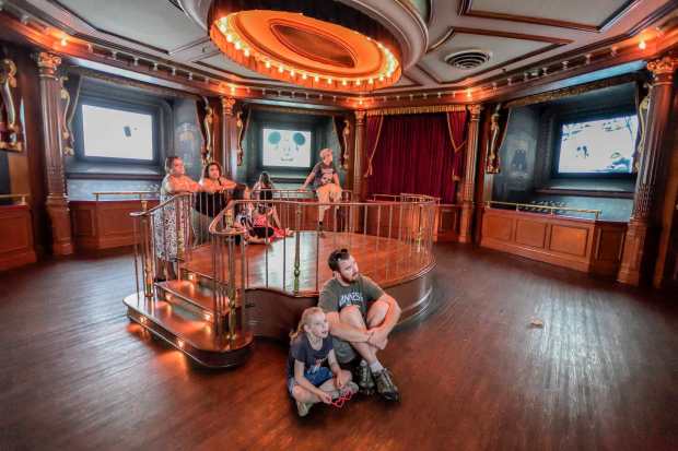 Rob Frenzel, of Anaheim, sits with his daughter Avery Frenzel, 5, as they watch old Mickey Mouse films inside the Main Street Cinema at Disneyland in Anaheim, California, on Wednesday, June 28, 2017.(Photo by Jeff Gritchen, Orange County Register/SCNG)