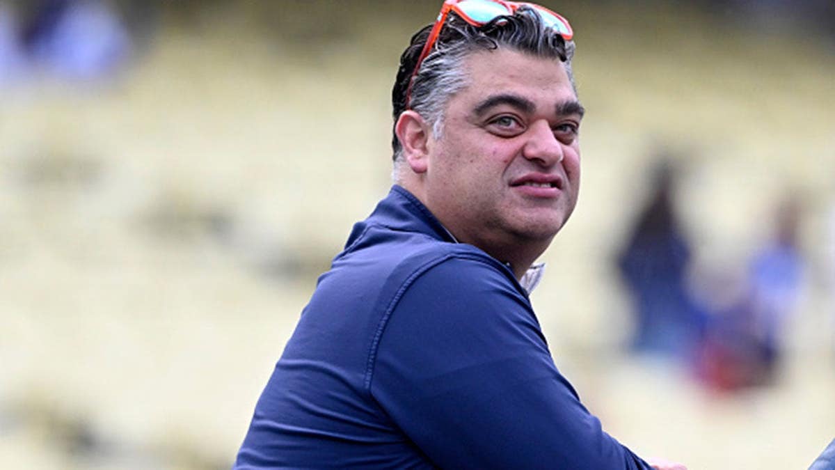 Perry Minasian stands during batting practice at Dodger Stadium.