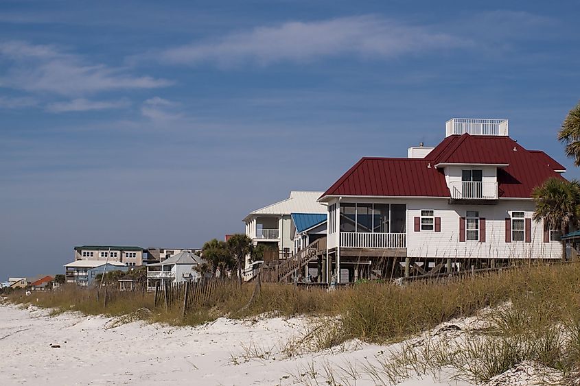 Low-rise beach houses along the wide shore at Mexico Beach, Florida.