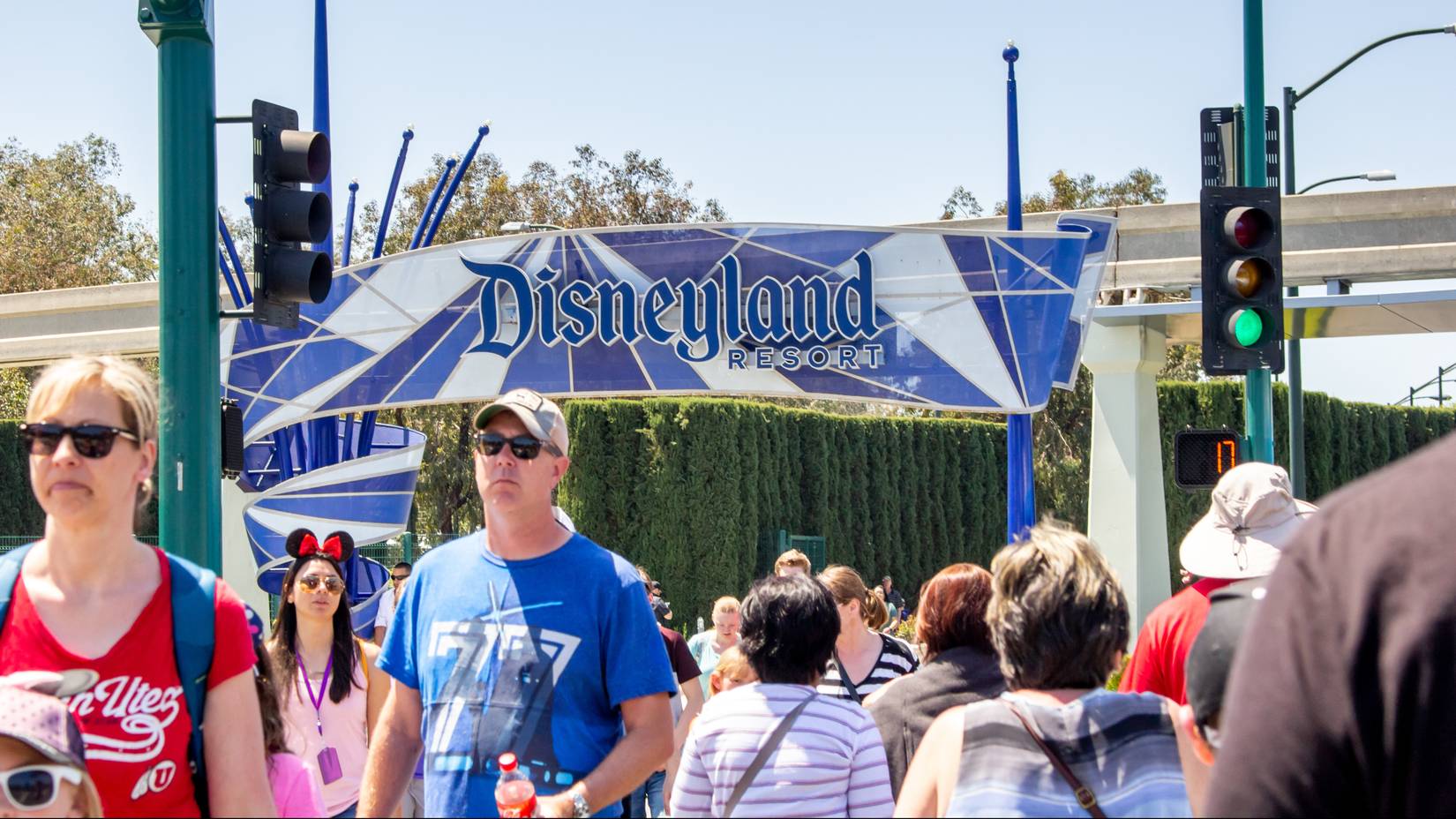 Tourists walk across the street towards Disneyland Resort, Anaheim, California