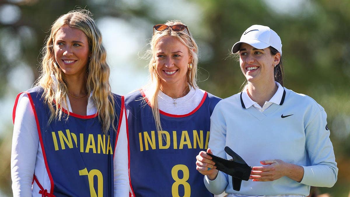 Professional basketball player Caitlin Clark (R) looks on with teammates Lexie Hull and Sophie Cunningham on golf course