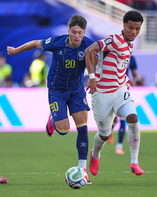 Bosnia's Esmir Bajraktarevic (20) and U.S. midfielder Malik Tillman (17) battle for the ball during the World Cup round of 32 soccer match between the United States and Bosnia in Santa Clara on Wednesday. (AP Photo/Julio Cortez)