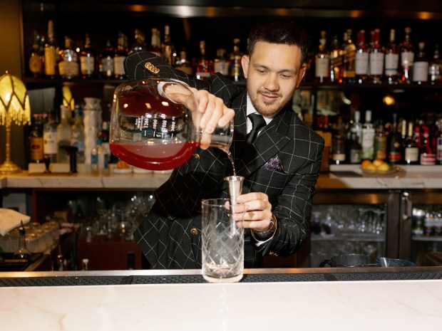 Mark Watten Jr., assistant director of food and beverage, prepares the After School cocktail at the newly reimagined Top of the Hyatt at the Manchester Grand Hyatt San Diego hotel in downtown San Diego. (Jarrod J. Photo)