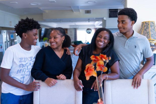 At their home in Fallbrook are Brenna Walker-Osuegbu, 54, and her children Bradan Osuegbu (right), 17; Jovah Osuegbu (left), 12; and Mekel Johnson, 20. The racism the family has faced there, and officials' responses to it, has left them wary of local schools. (Nelvin C. Cepeda / The San Diego Union-Tribune)
