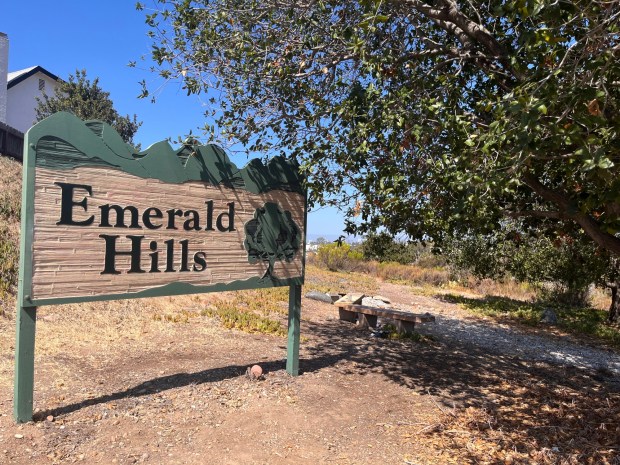 The trail begins near a large sign and bench, welcoming visitors and residents to Emerald Hills. (Maura Fox / The San Diego Union-Tribune)