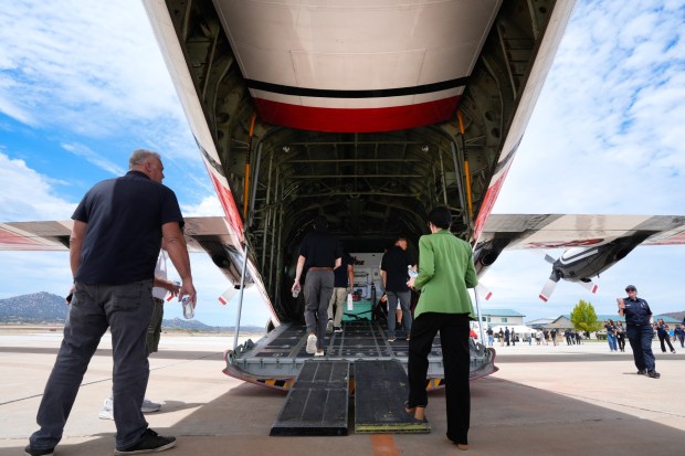 People tour the C-130 air tanker on the flight line at Ramona Air Attack Base on Monday. (Nelvin C. Cepeda / The San Diego Union-Tribune)
