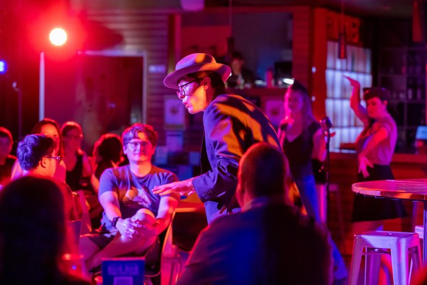 Cole Chinn croons to the audience in a scene from Blindspot Collective's new jukebox musical "Dive Bar Time Machine" at The Loft at UC San Diego in La Jolla. (Joe Kao)