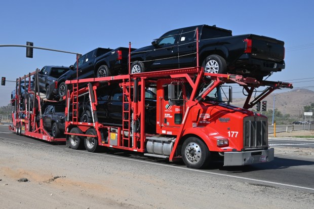A truck carrying Tacoma pickup trucks at the Toyota Motor Corp assembly plant in Tijuana, Mexico on Wednesday, July 08, 2026, after the Japanese automaker announced it will invest $3.6 billion to expand its San Antonio manufacturing campus with a second vehicle assembly line and transition Tacoma production from Toyota Motor Manufacturing Baja California to the expanded Texas plant over an approximate four-year period. (Carlos Moreno / The San Diego Union-Tribune)