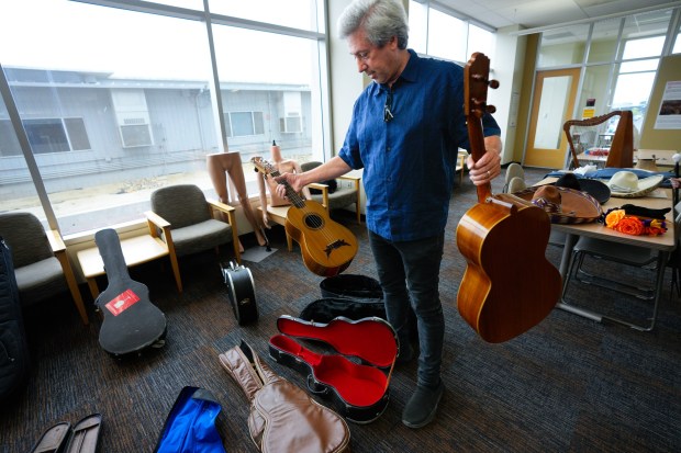 On Tuesday, June 23, 2026, Southwestern College Professor Jeff Nevin packs some of the guitars from the Mariachi Museum on campus.The museum is in the process of packing up and, for now, going into storage until a new location can be found. (Nelvin C. Cepeda / The San Diego Union-Tribune)