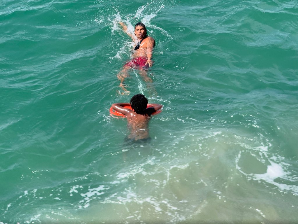 A lifeguard rescues a swimmer in the ocean near Venice Beach.