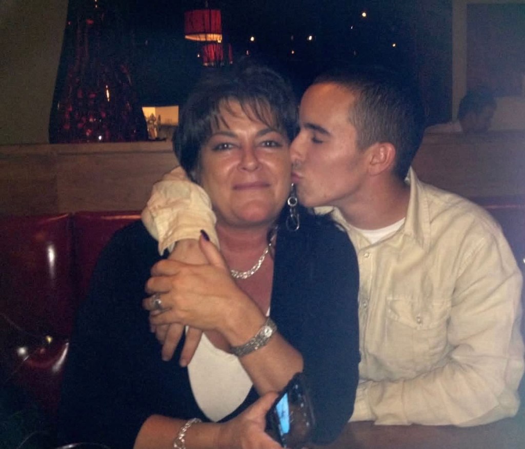 Tondra Madruga with her brother, Quin Madruga, who is kissing her cheek.