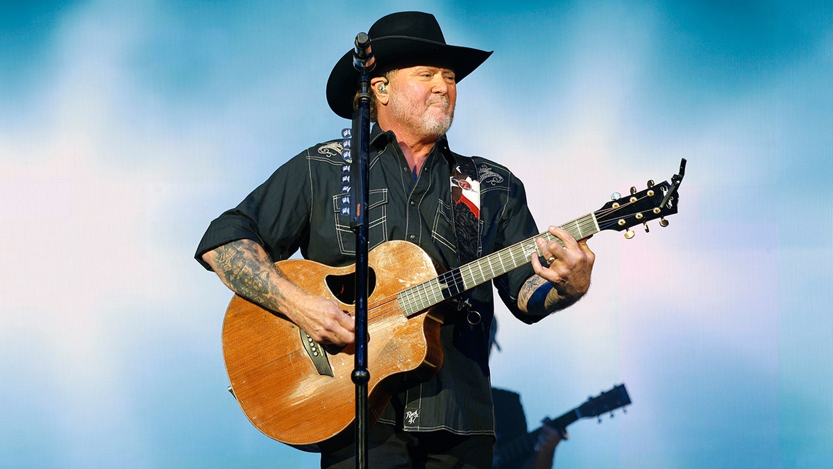 Tracy Lawrence performing live on stage at the Ryman Auditorium in Nashville, Tennessee.