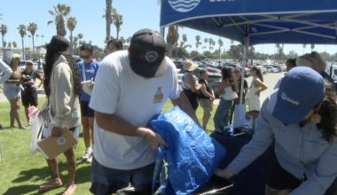 Volunteers clean up Mission Beach the day after July 4th holiday
