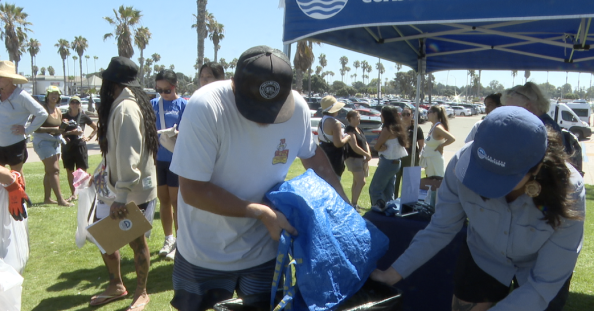 Volunteers clean up Mission Beach the day after July 4th holiday