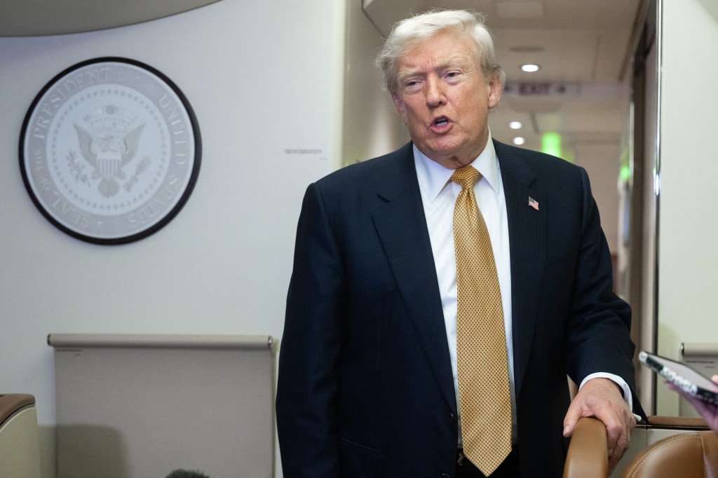 Donald Trump speaks with media aboard Air Force One.