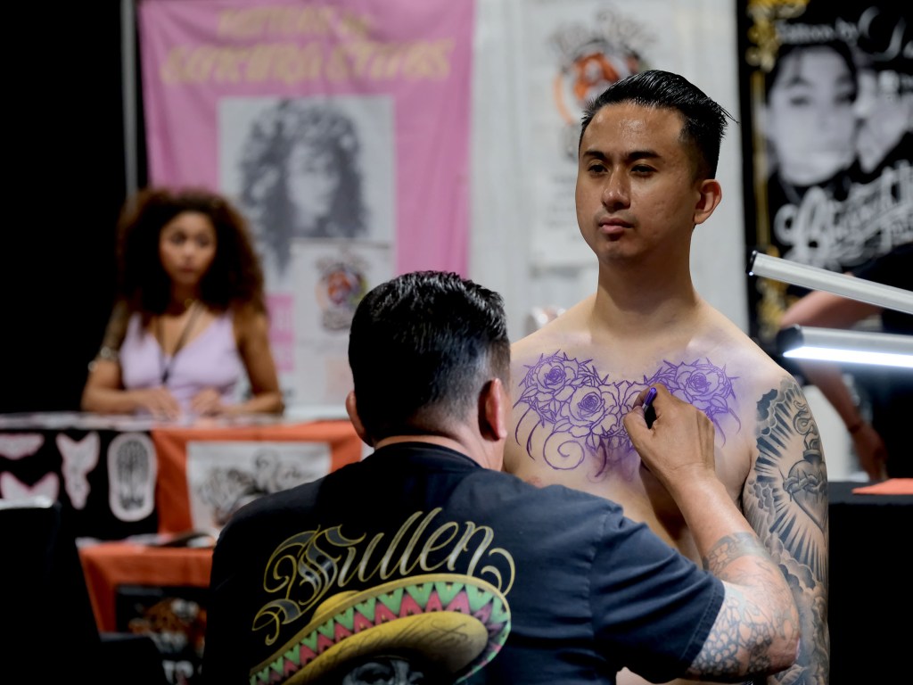 Tattoo artist at Long Beach Tattoo Arts Festival 2026 at the Long Beach Entertainment Center.