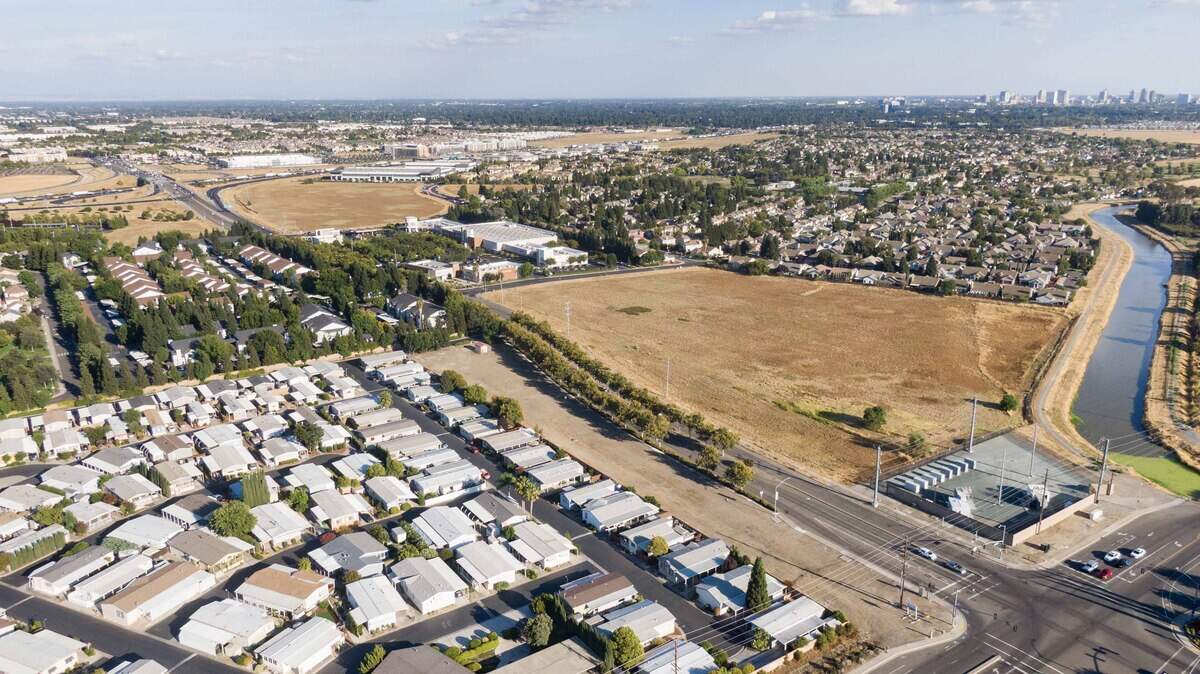 Vehicles drive past a long, slender parcel at the corner of El Centro Road and Arena Boulevard in North Natomas last year. The city-owned property was a planned site for tiny homes for homeless seniors.