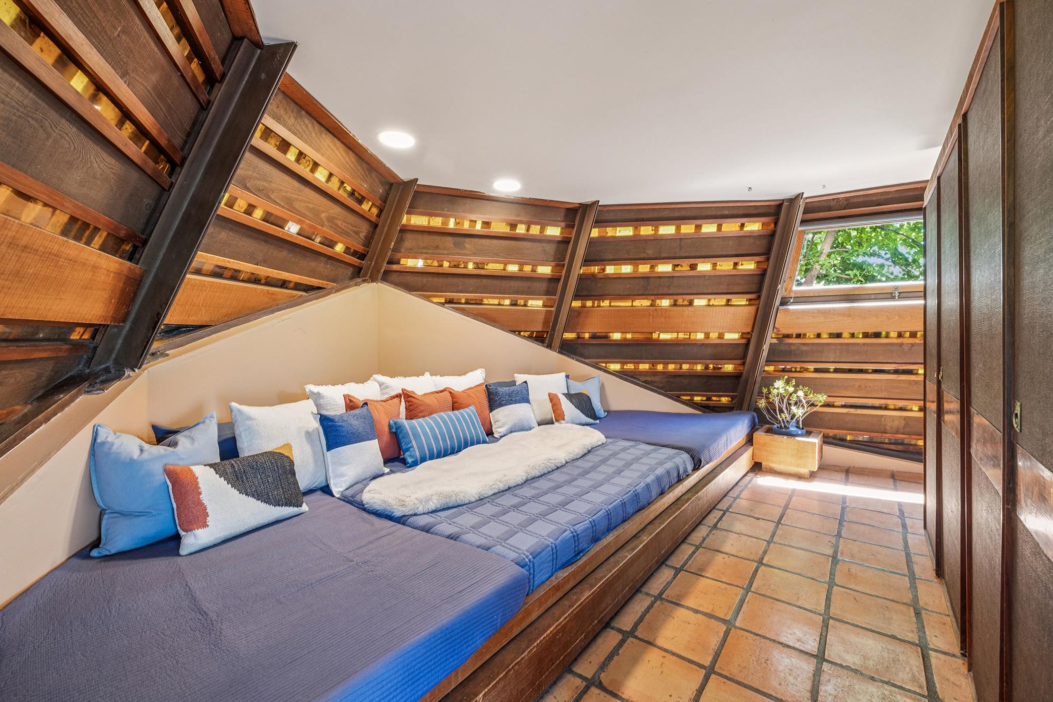 A nook with a built-in bed on the ground level serves as the primary bedroom