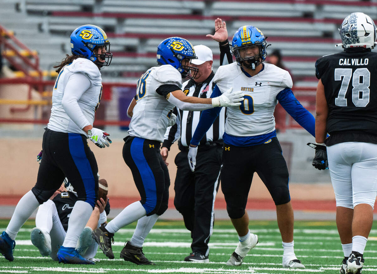Sutter Huskies defensive end Troy Bowens (0) is congratulated by defensive end Richard Creer (28) after he sacked Casa Roble Rams quarterback Aidan Lopez in the CIF Sac-Joaquin Section Division V championship at Hughes Stadium in Sacramento on Friday, Nov. 28.