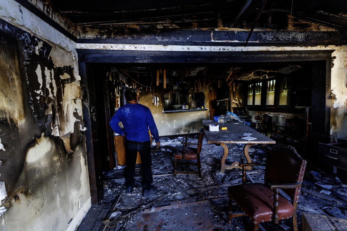 Pastor Juan Galicia is still in disbelief as he stands in his burned Larchmont home.