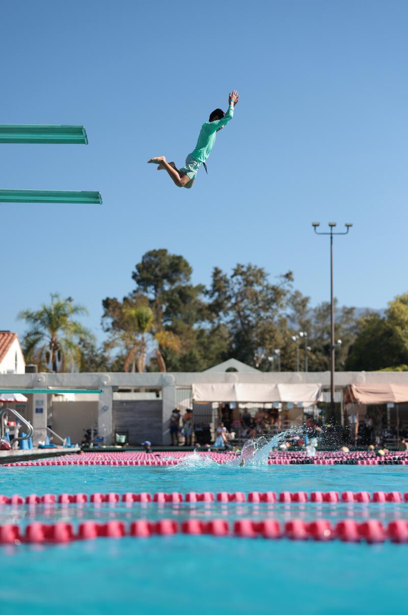 A child jumps off a diving board.