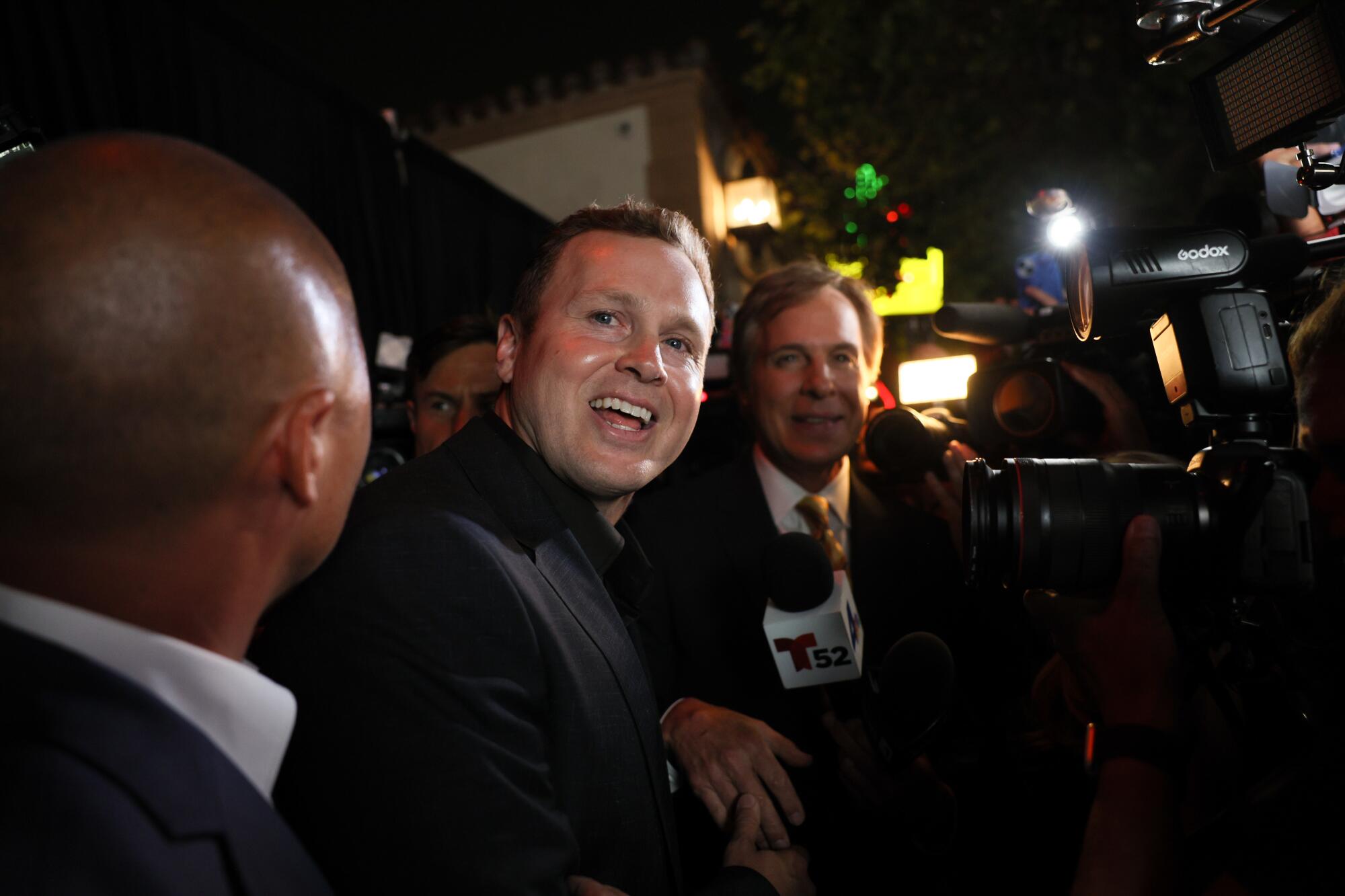 June 2 photo of Spencer Pratt standing next two two men.