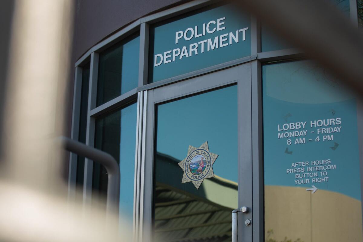A door with the words 'police department' along with the seal of the University of California police