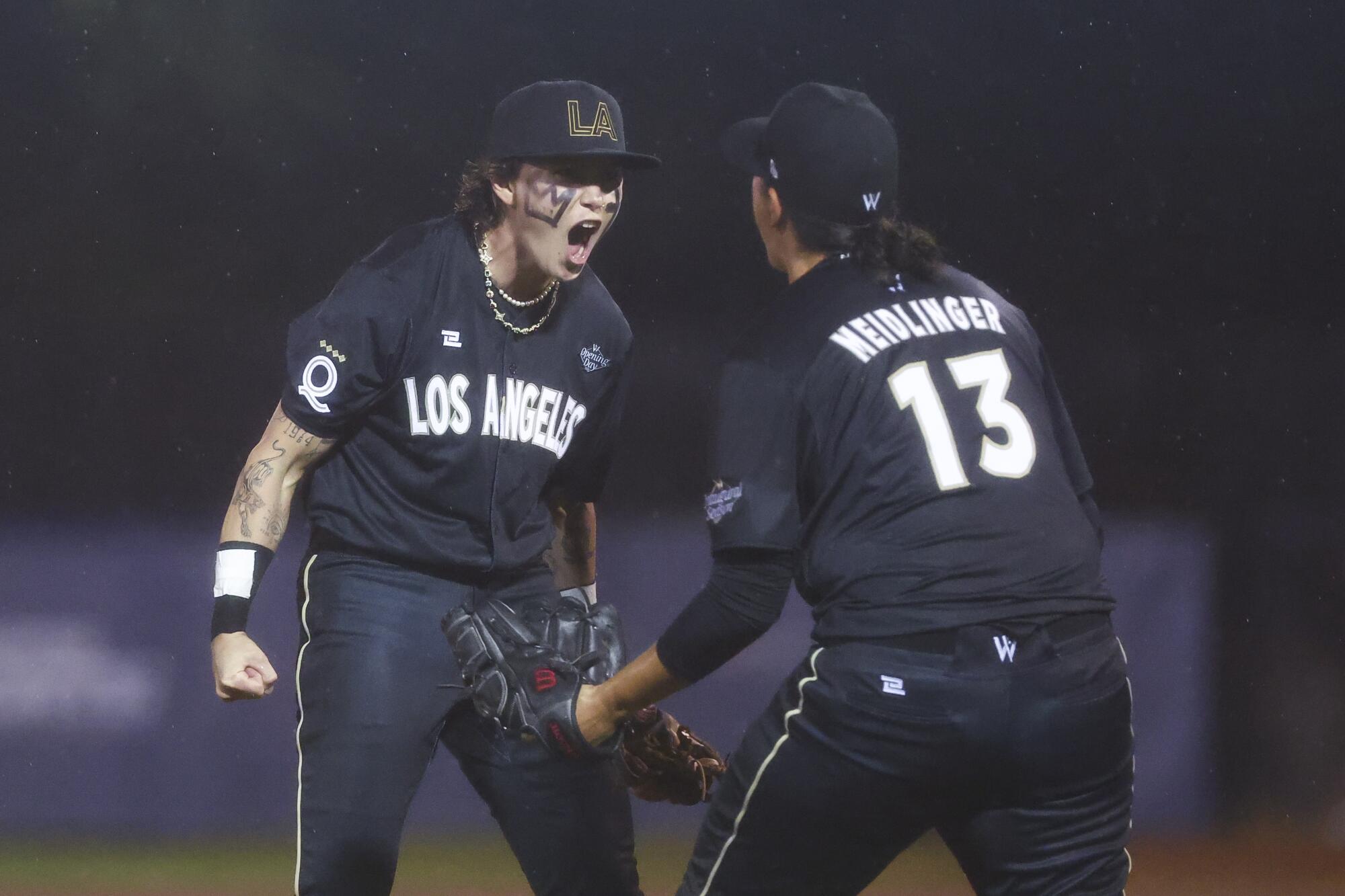 The Los Angeles Queens' Ashton Lansdell and Meggie Meidlinger celebrate after beating the New York Heights.