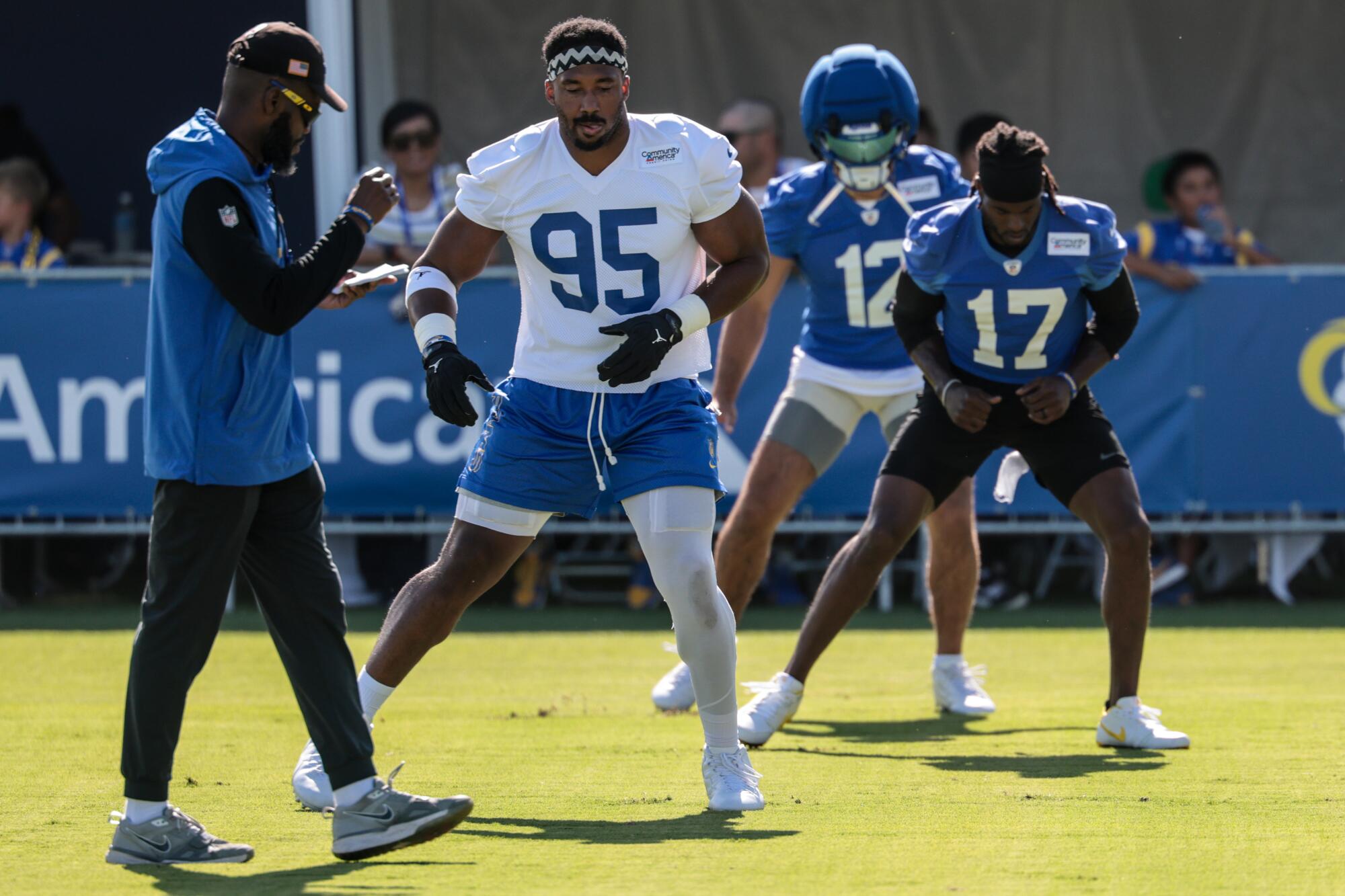 Myles Garrett (95) takes part in training camp along with wide receivers Puka Nacua (12) and Davante Adams (17) on July 26.