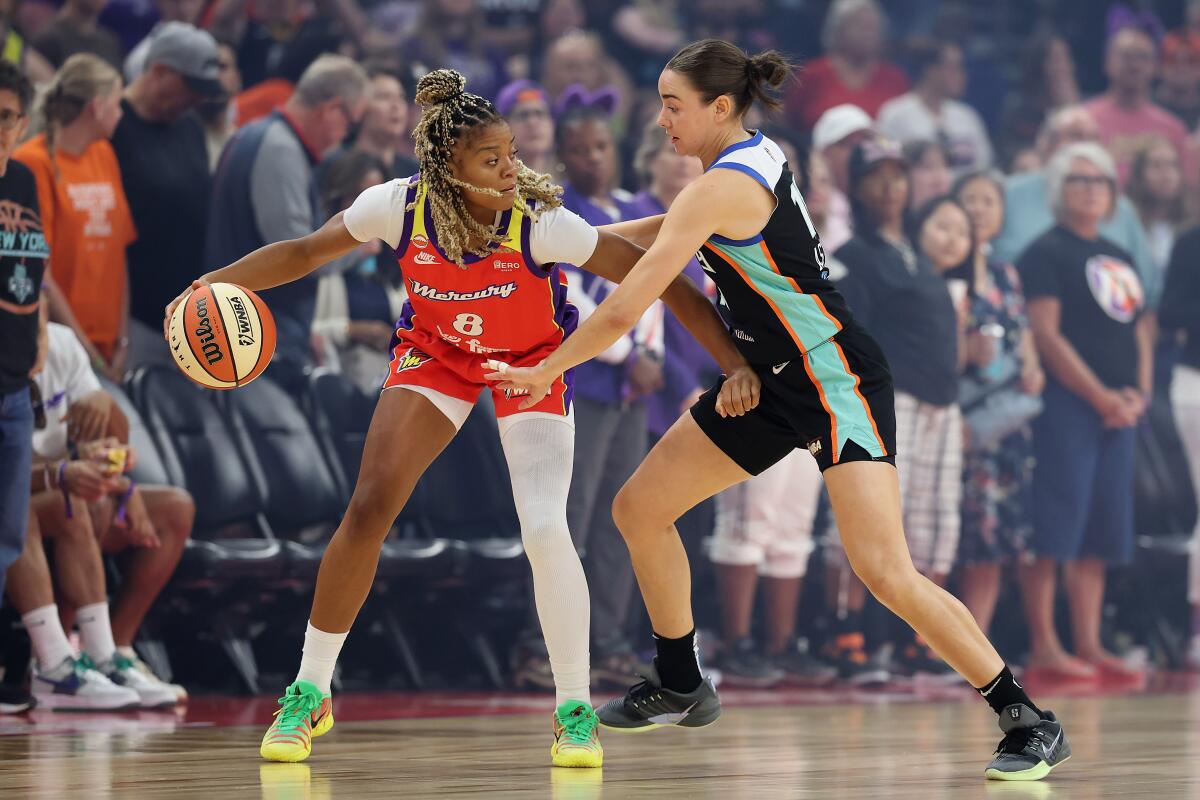 The Mercury's Monique Akoa Makani handles the ball in front of the Liberty's Pauline Astier.