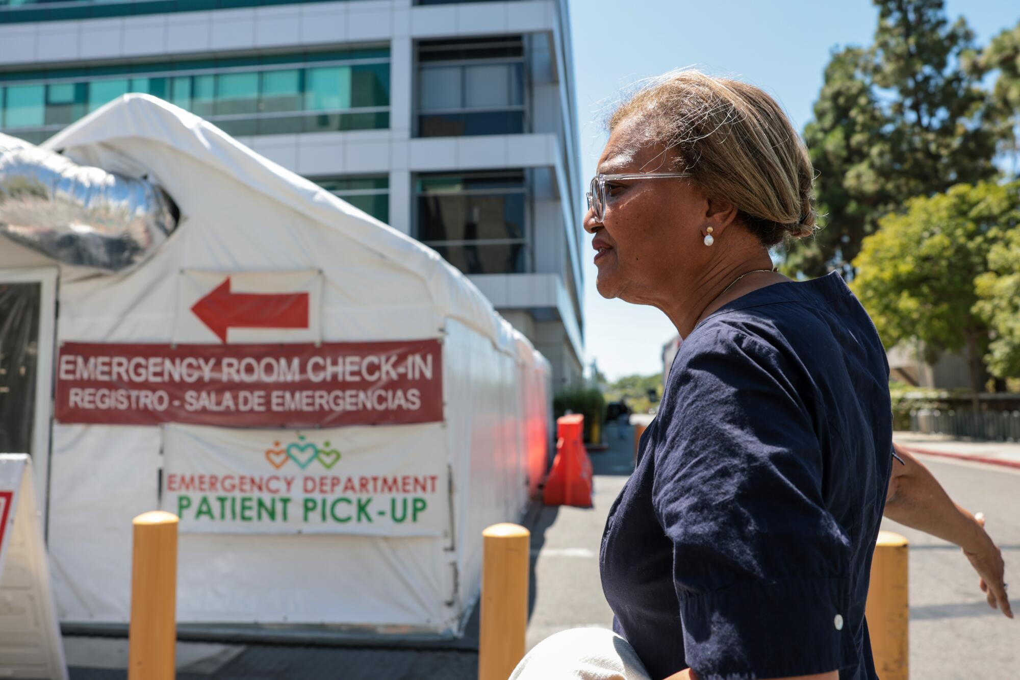 MLK Hospital CEO Dr. Elaine Batchlor near a tent used for emergency room intake.