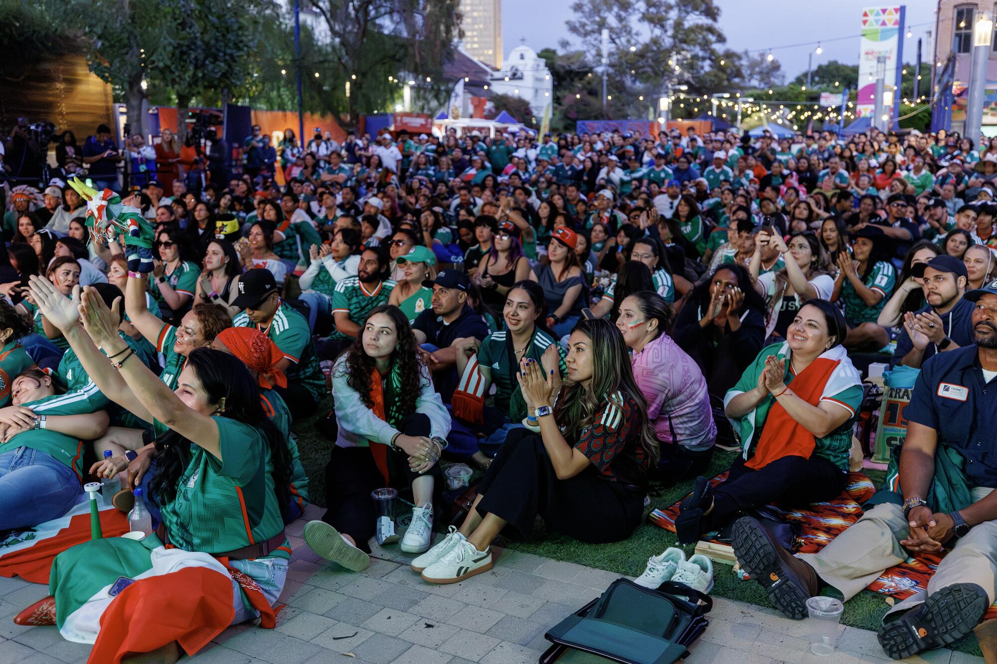Fans cheer during a watch party at LA Plaza de Cultura y Artes during a World Cup match between Mexico and Ecuador.