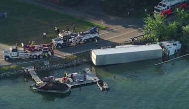 Semi overturns into Pine Lake along Pine Lake Road in Oakland County; driver suffers injury