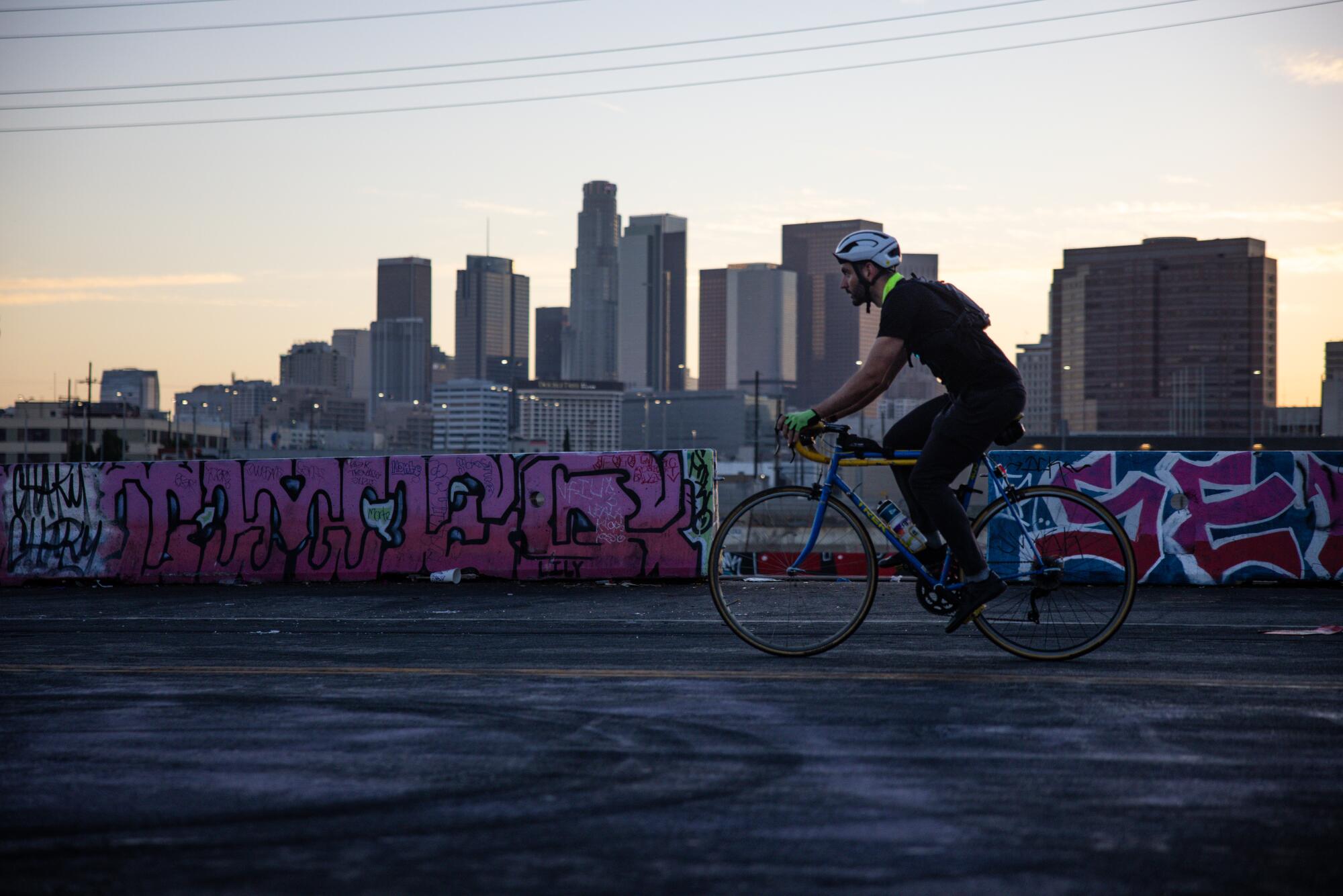 Marc Papas cycles past graffiti 