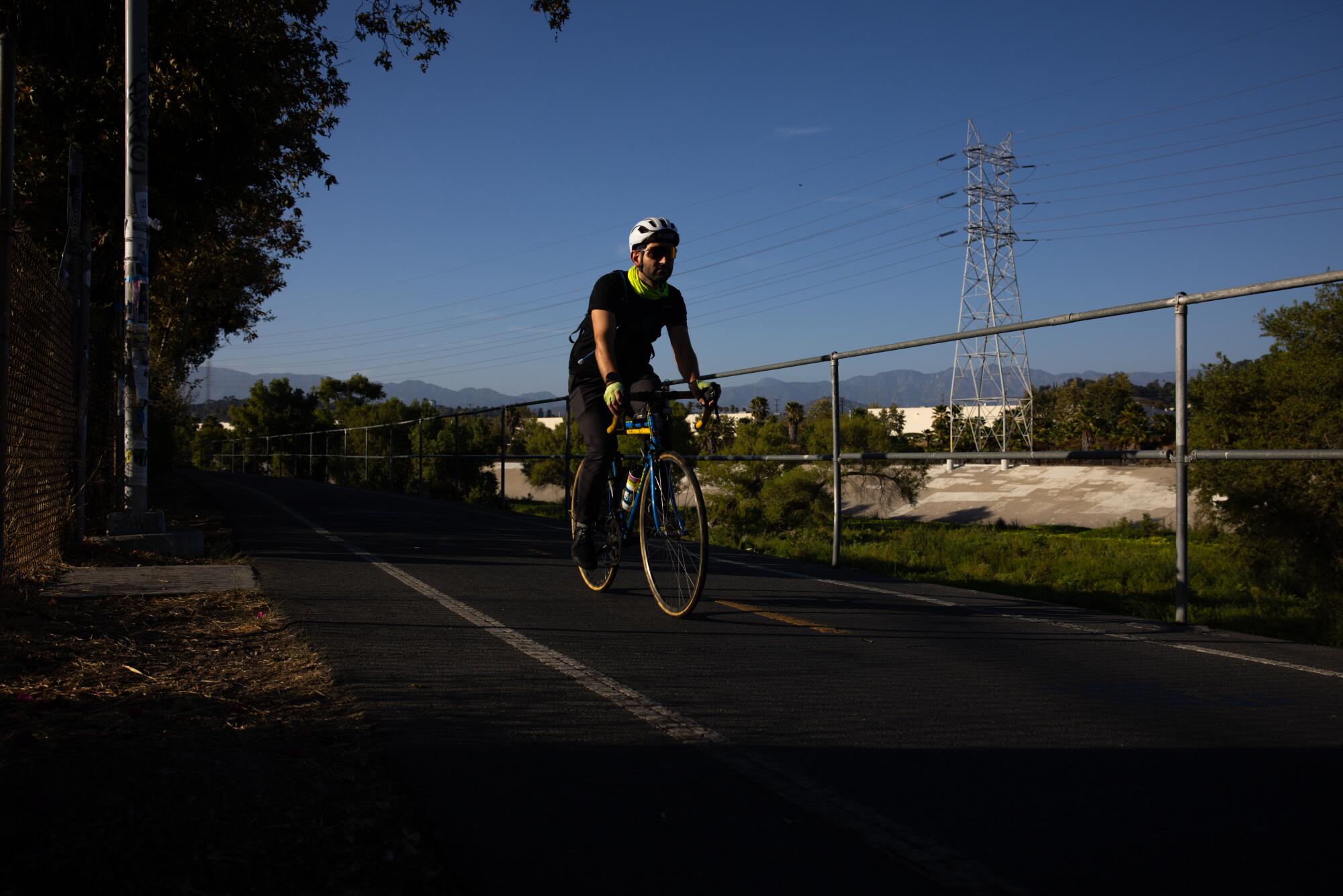 Marc Papas cruises along the Los Angeles River bike path.