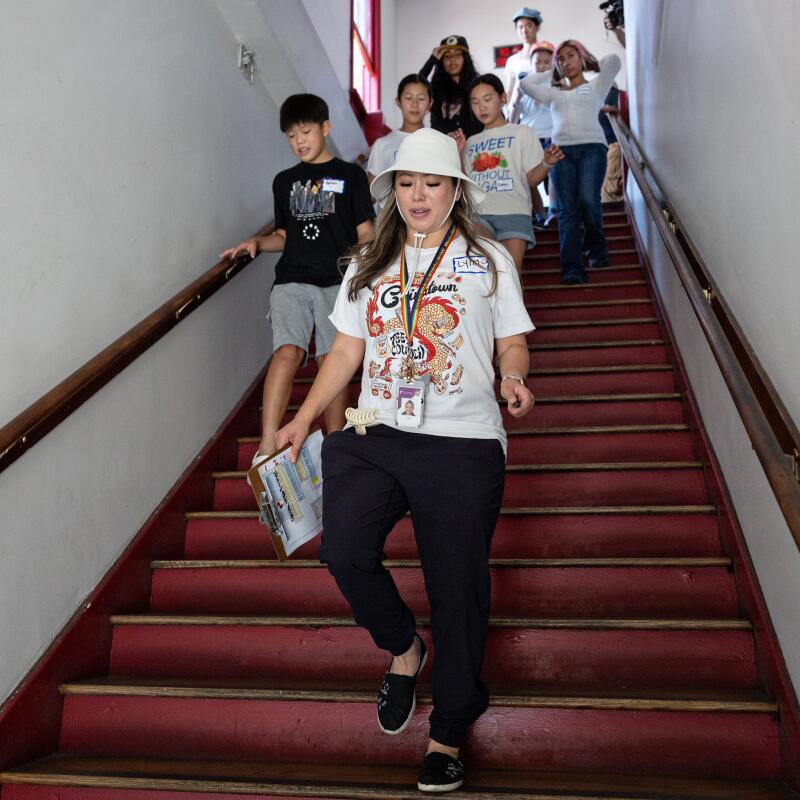 Chinatown librarian Lynn Nguyen leads a group of teens in packing and delivering a variety of fresh produce and food to people in need throughout Chinatown.