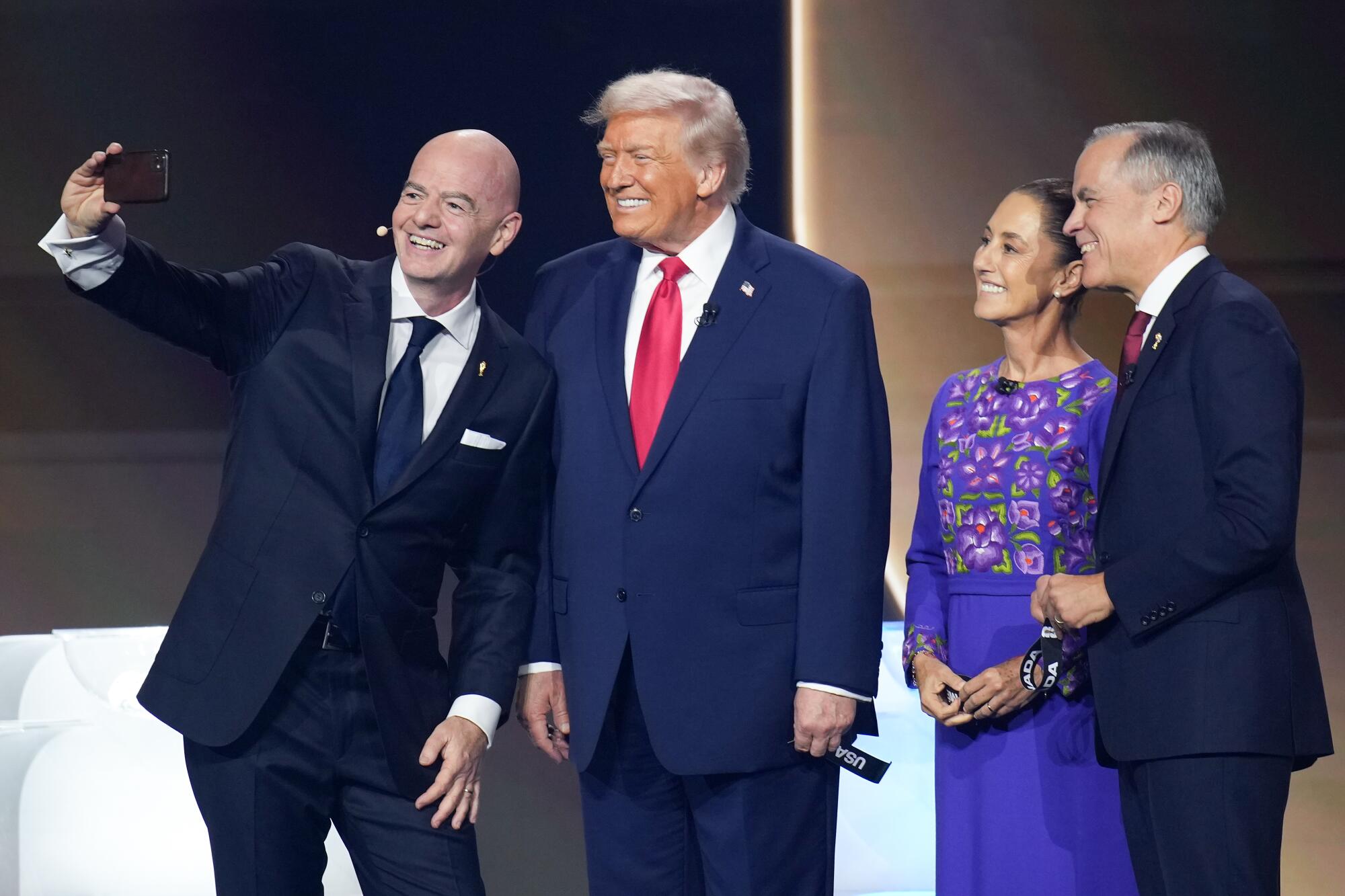 FIFA president Gianni Infantino, far left, takes a selfie with President Trump.