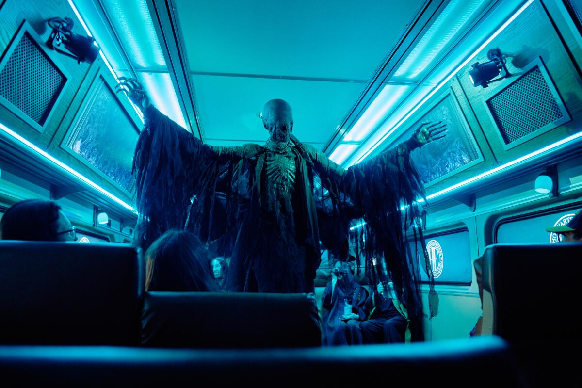 A dementor puppet moves through the train in “Harry Potter: A Hogwarts Express Adventure.”