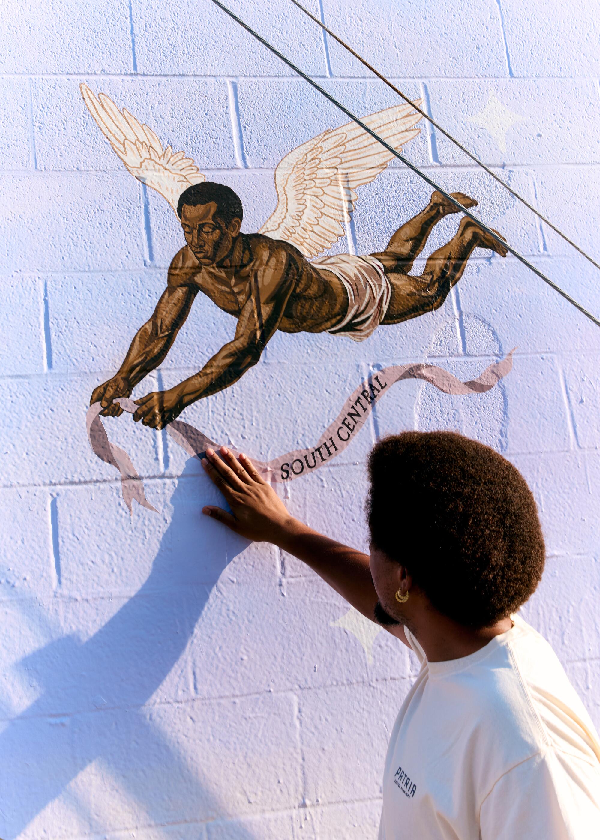 Artist Anthony Pittman with a detail of the first mural of his "Los Angelitos" series. Jennelle Fong / For The Times.
