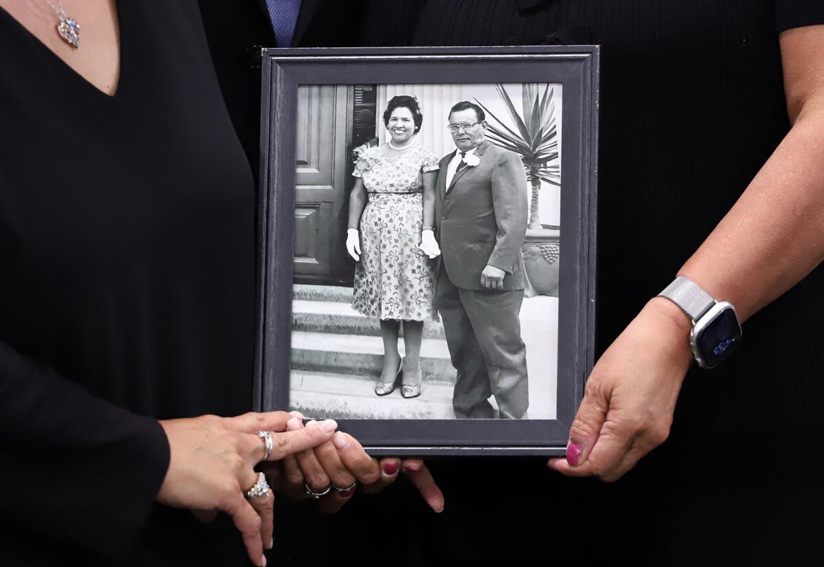 A picture of Frank and Irene Palomino held during a Garden Grove Unified School District meeting last month.