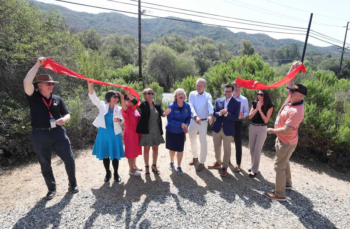 State, county, local and Caltrans officials participate in a ribbon cutting ceremony in Laguna Canyon on Tuesday.