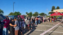 Families in line, Saturday, to receive free backpacks with school supplies at an annual giveaway in Encanto, August 8, 2026.