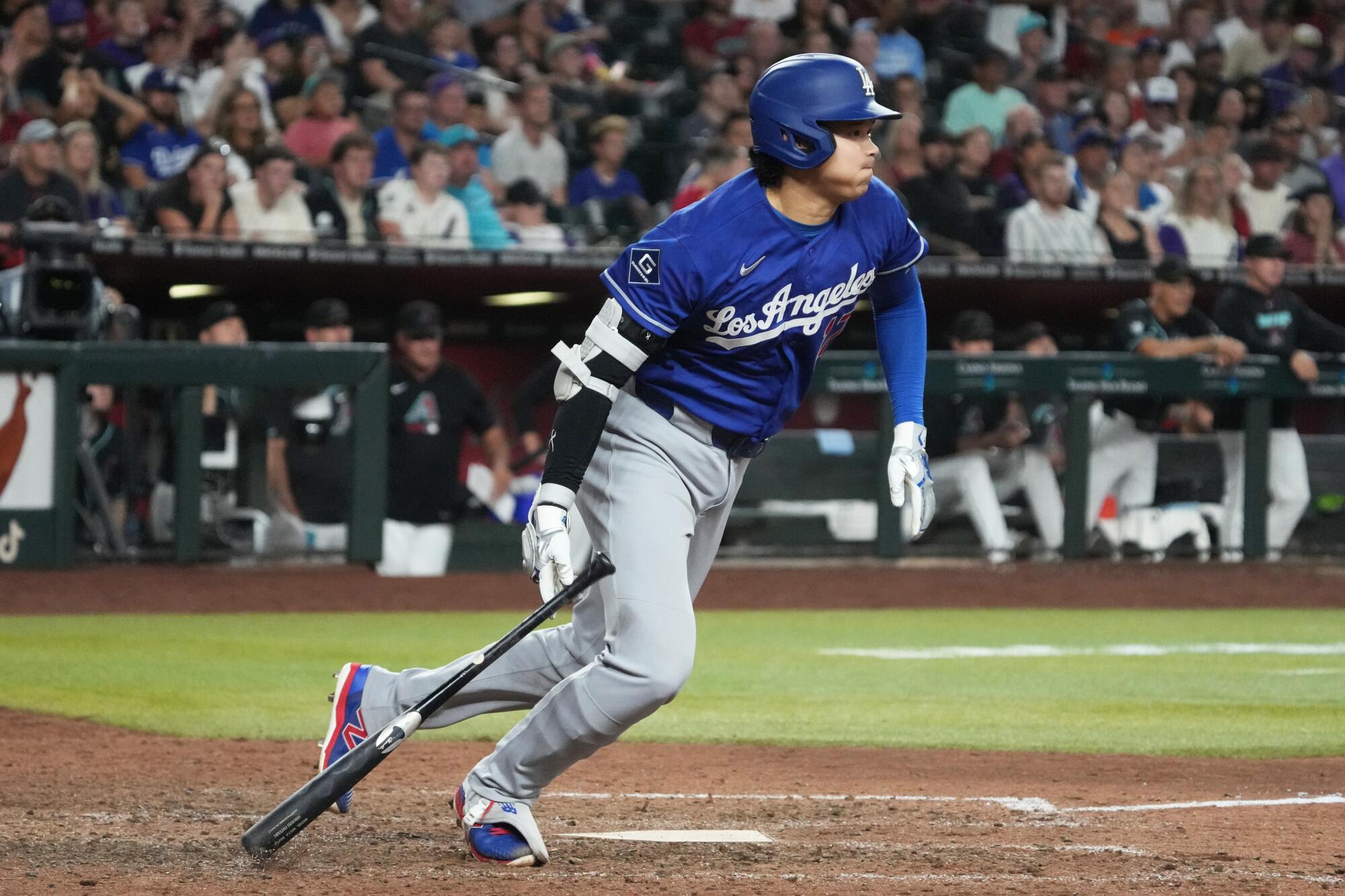 Dodgers star Shohei Ohtani hits an RBI single in the 10th inning against the Diamondbacks on Saturday.