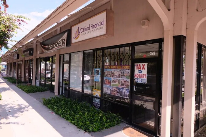 A stripmall of small businesses, including Citifund Financial in the foreground.