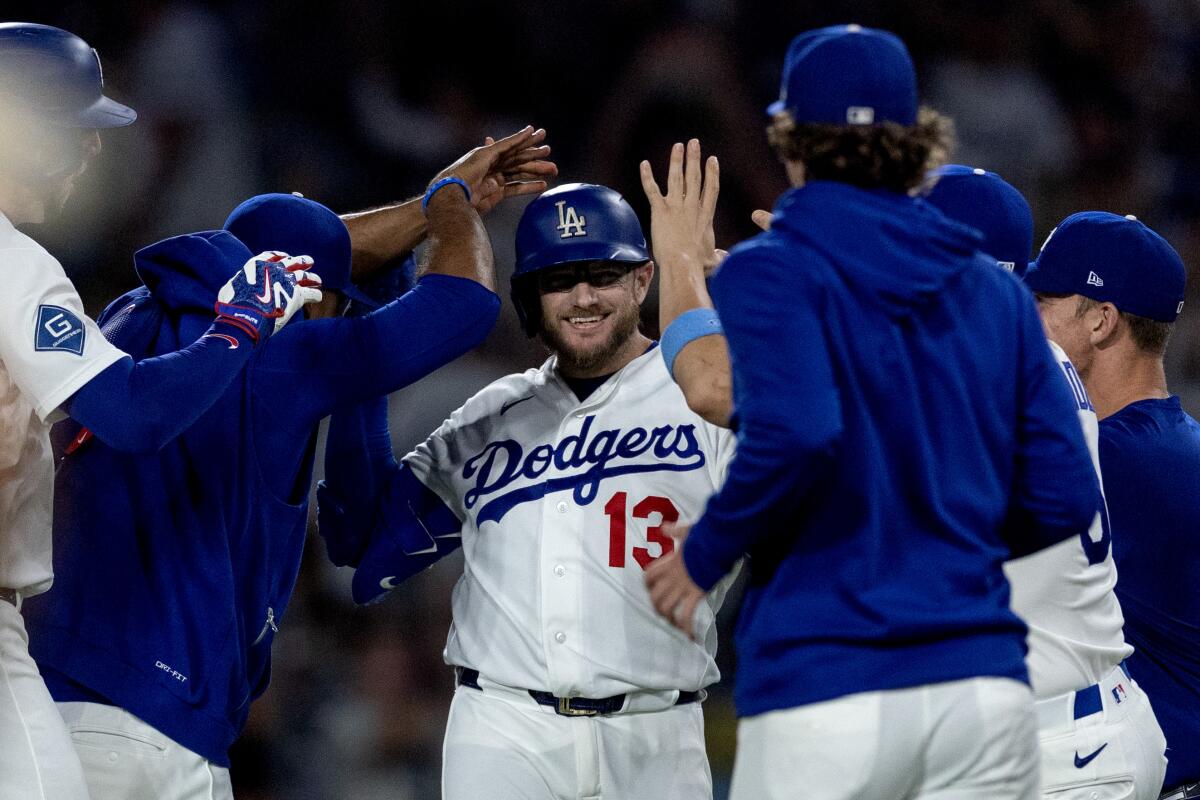 Max Muncy and teammates celebrate after his walk-off single Tuesday.